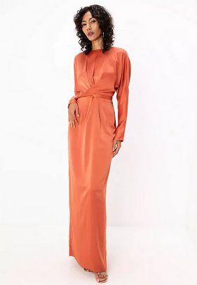 Woman wearing an orange long-sleeve dress on a white background