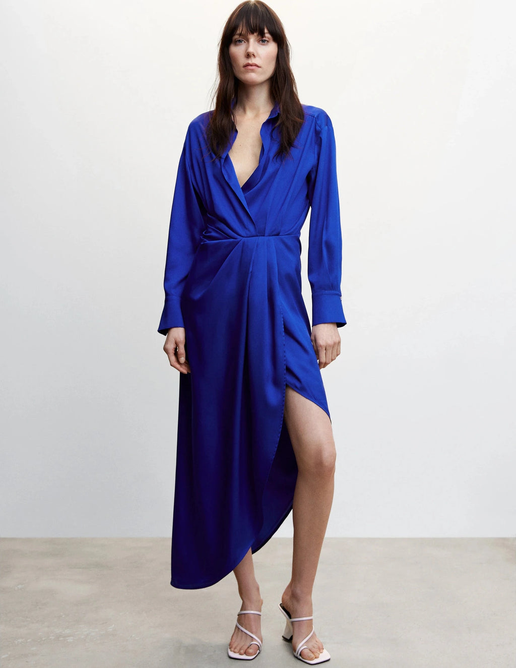 Woman wearing a blue dress against a plain background