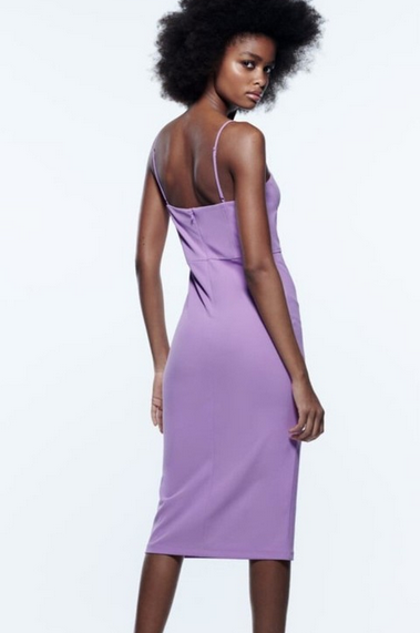 Woman wearing a purple dress on a white background