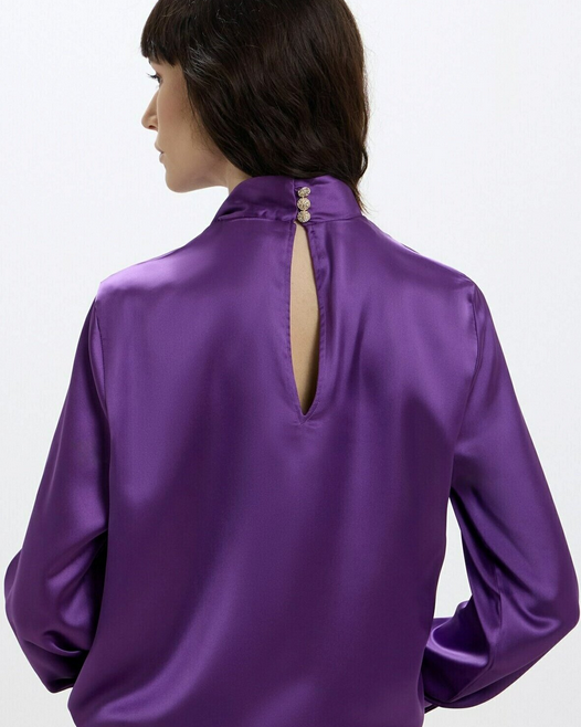 Purple satin blouse with open back on a white background