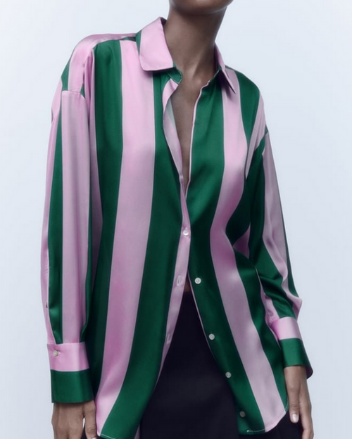 Green and pink striped shirt worn by a model on a white background