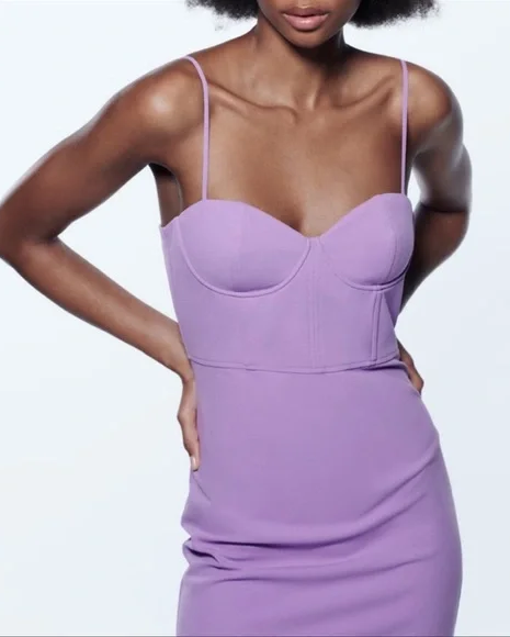 Woman wearing a purple dress against a white background