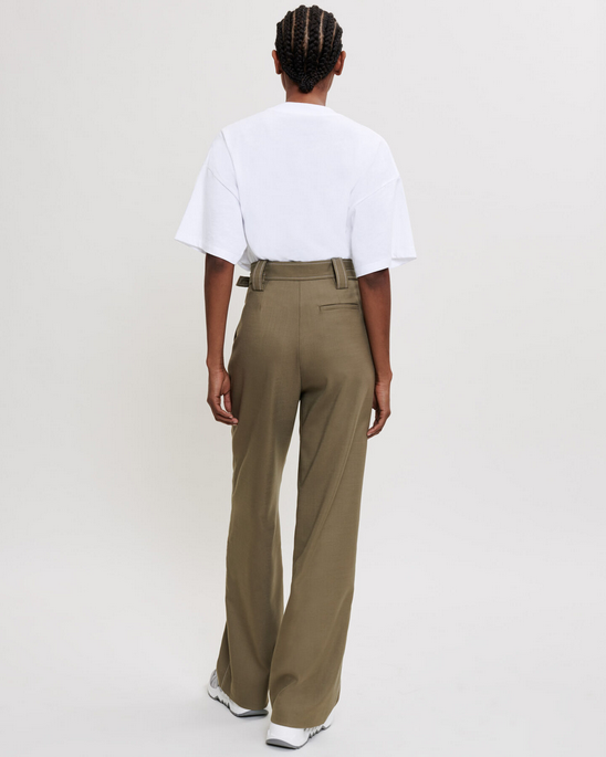 Person wearing a white t-shirt and olive green pants on a plain background