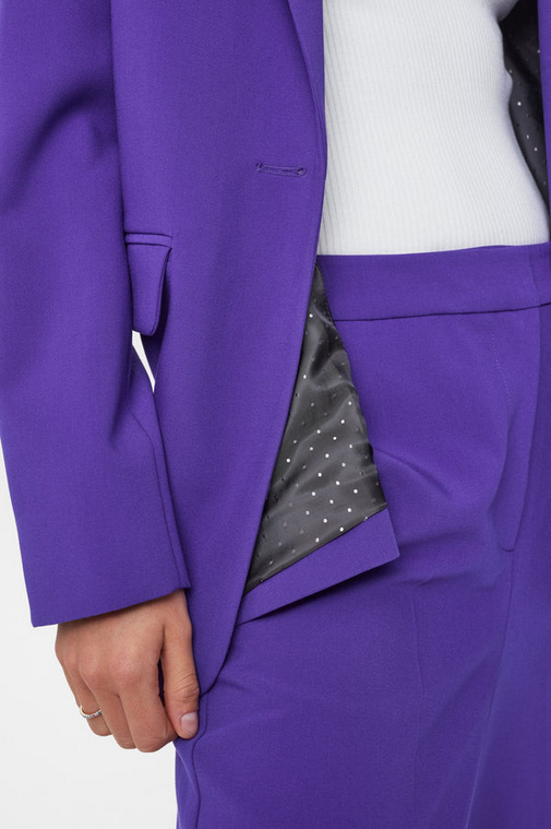 Purple suit with a white shirt and gray patterned lining.