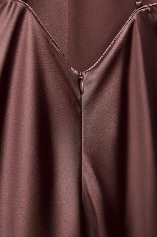 Close-up of a brown garment with a zipper detail