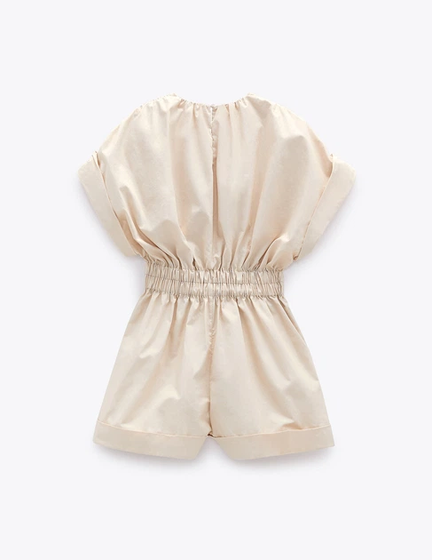 Beige romper on a white background